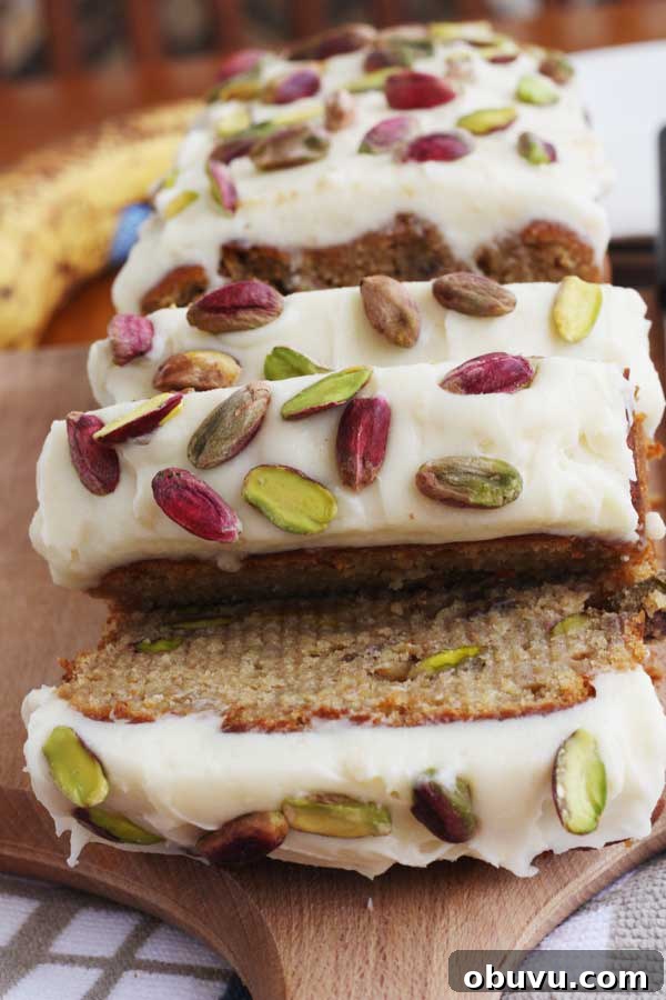 Banana Pistachio Cake with White Chocolate Cream Cheese Frosting 9 closeup of slices of banana and pistachio loaf with white chocolate cream cheese frosting
