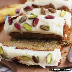 Banana Pistachio Cake with White Chocolate Cream Cheese Frosting 10 Slices of banana pistachio cake sliced off the rest of the cake
