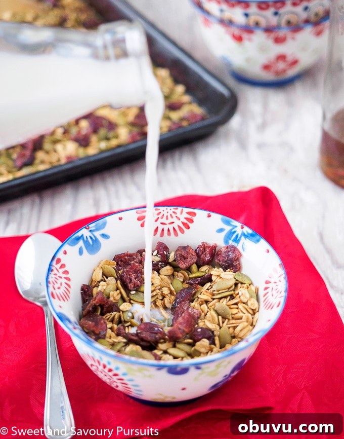 Crunchy Pumpkin Seed Granola Recipe – Homemade Fall Breakfast 4 Bowl of Healthy Pumpkin Seed Granola being topped with milk.