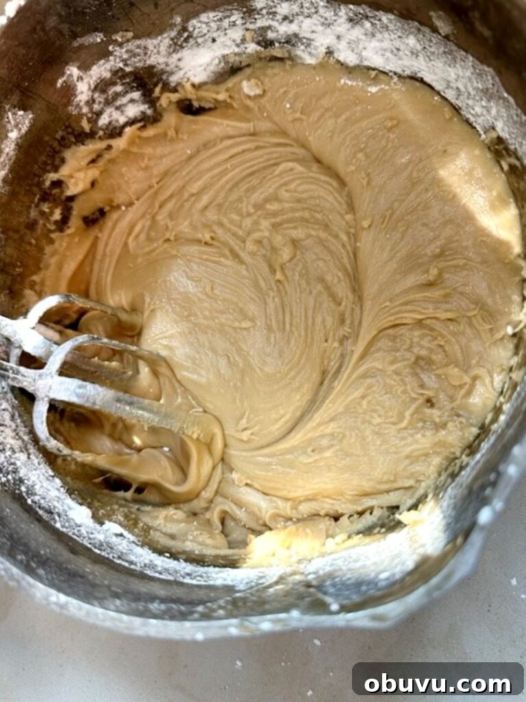 Irresistible Peach Cake Recipe You'll Make Again and Again 11 beating powdered sugar into caramle frosting