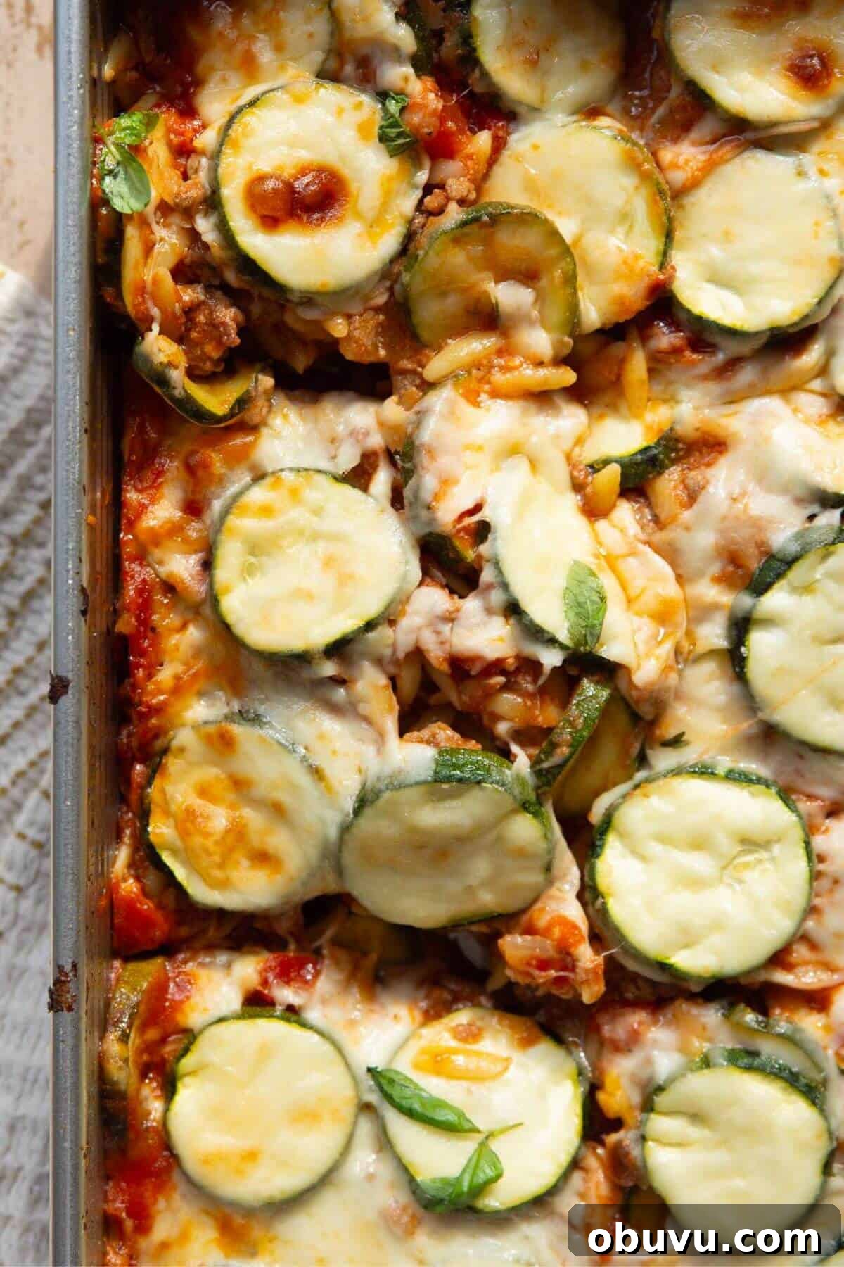 Lightened-up ground beef and zucchini casserole with cottage cheese and fresh zucchini, baked until golden and bubbly.