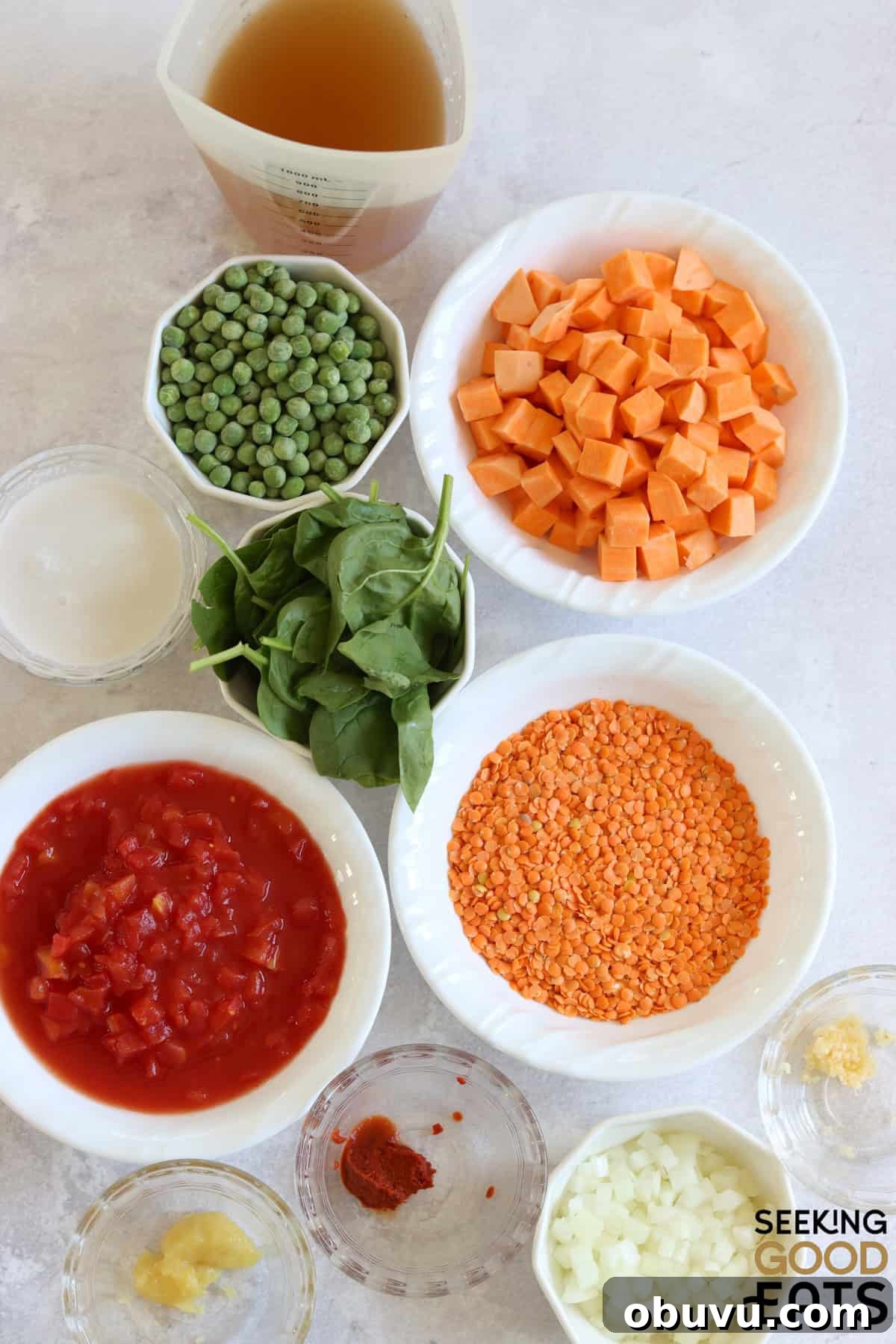 Ingredients to make sweet potato red lentil curry recipe on a white marble countertop.