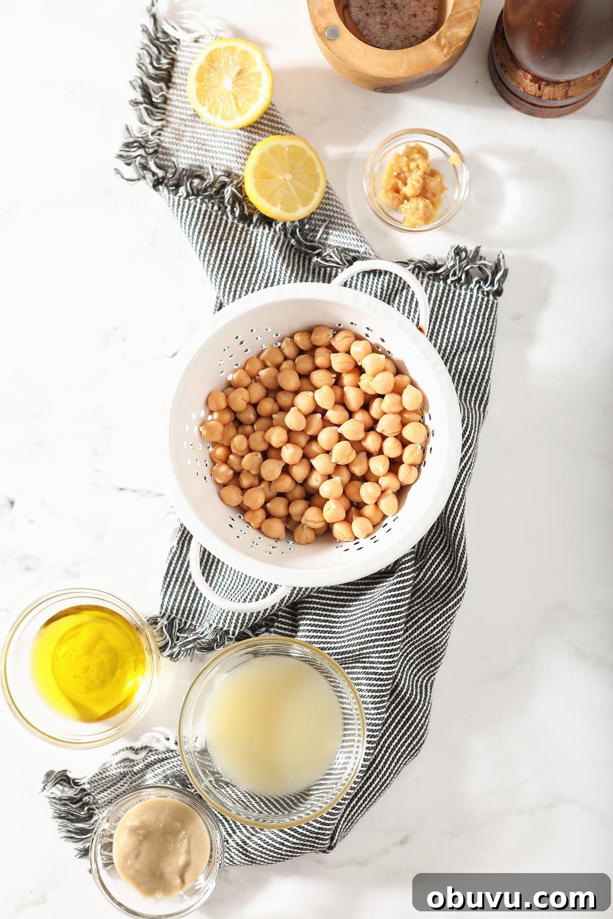 Winston’s Roasted Garlic Hummus Recipe 3 Chickpeas in a colander are surrounded by other ingredients, before the dip is made