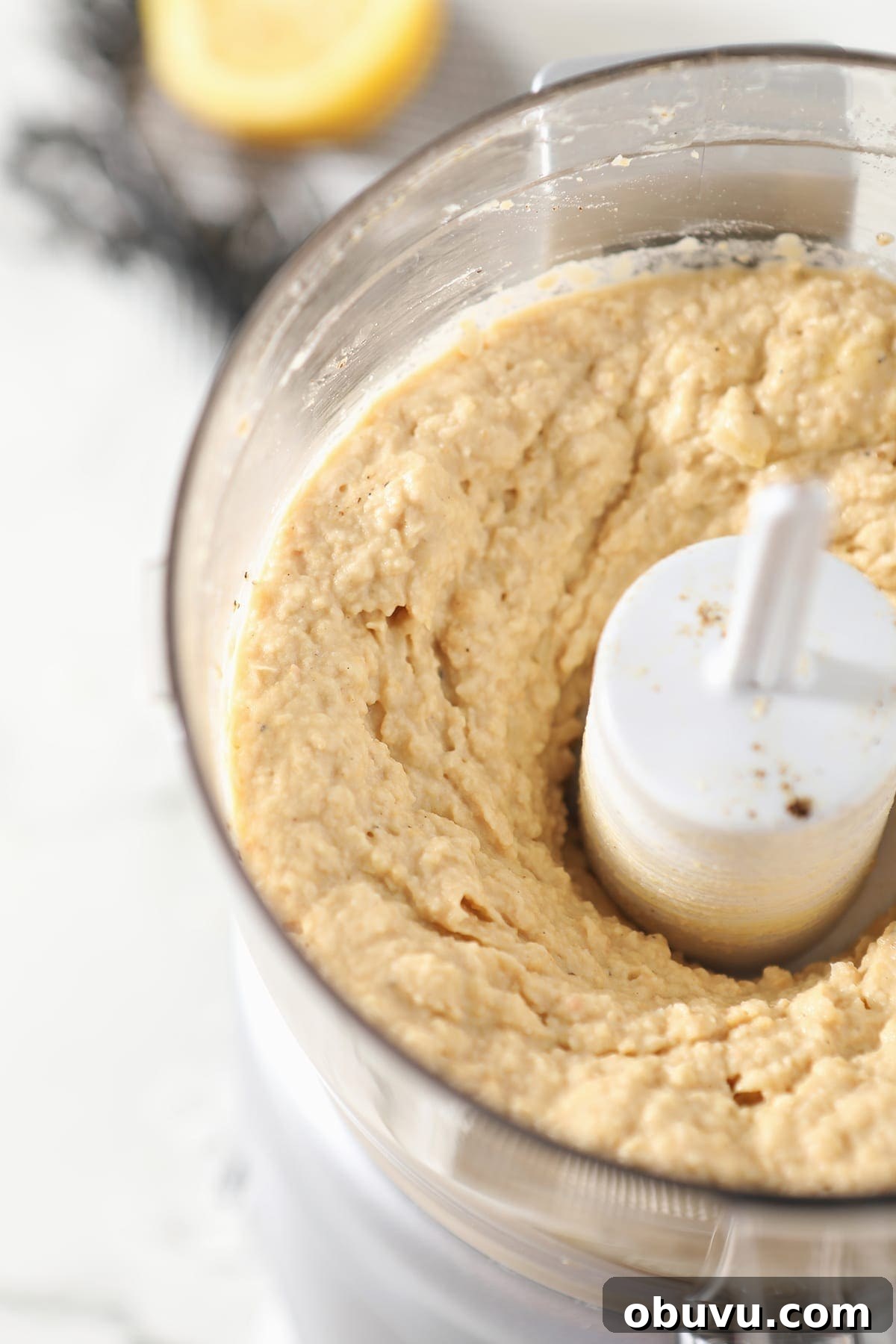 Winston’s Roasted Garlic Hummus Recipe 5 Close up of a food processor after hummus ingredients blended together