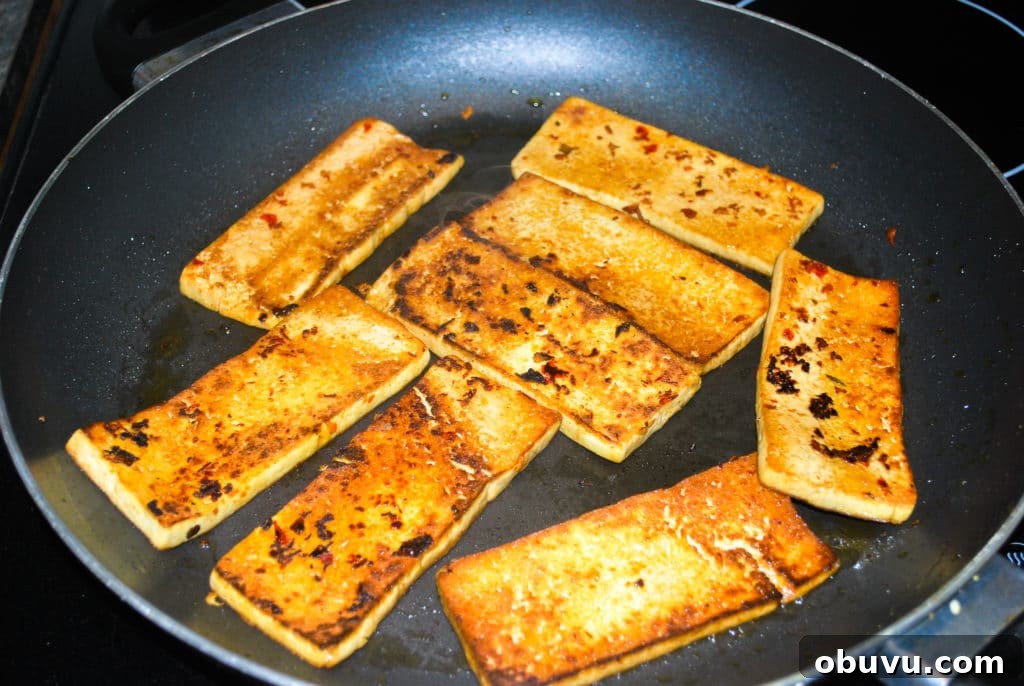 perfectly cooked seared tofu in a frying pan