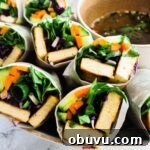 A close up view of banh mi summer rolls on a plate.