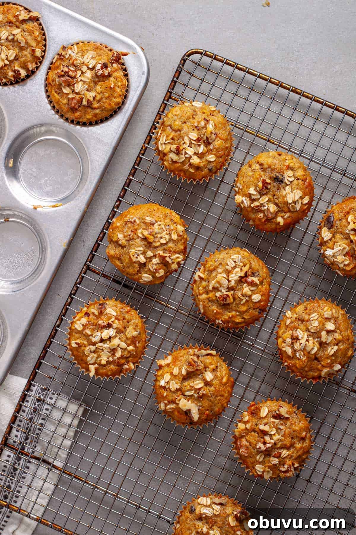 Carrot banana muffins cooling on a wire rack.