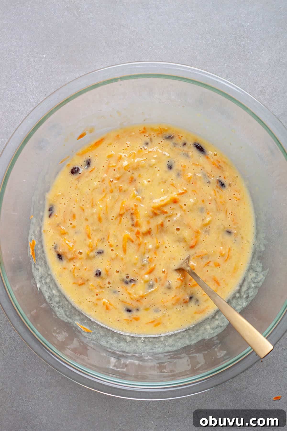 Wet ingredients for carrot muffins mixed together in a large bowl.