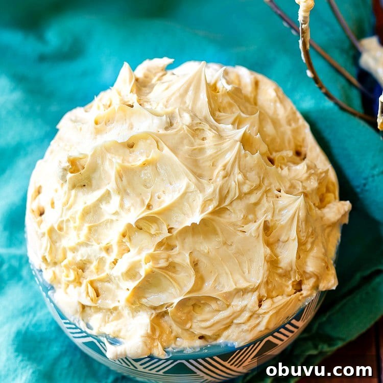 Burnt Caramel Buttercream Recipe for Whipped Frosting 3 An overhead shot of a bowl of burnt caramel buttercream on a blue cloth napkin.