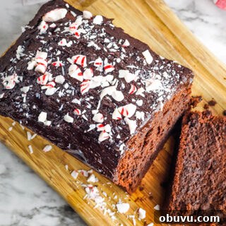 Chocolate Peppermint Pound Cake Recipe — Festive Holiday Dessert 13 Peppermint Chocolate Pound Cake with crushed peppermint candy on top on wooden serving board