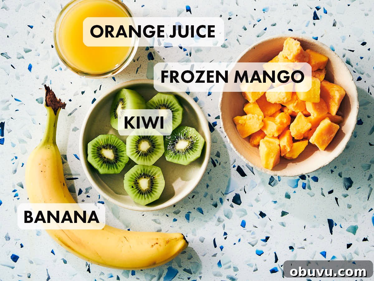 Refreshing Mango and Kiwi Smoothie Recipe for Glowing Mornings 4 Mango, kiwi, banana and orange juice on a kitchen counter.