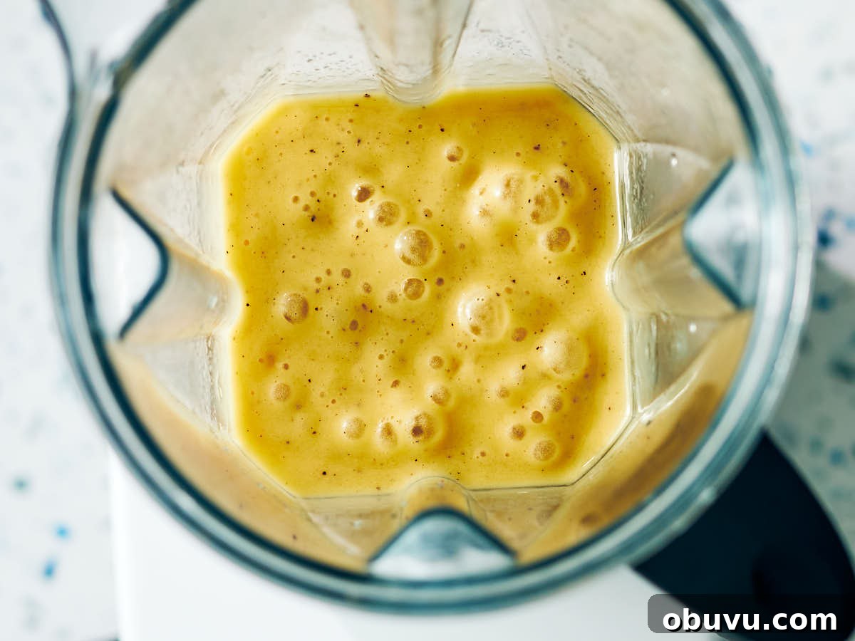 Refreshing Mango and Kiwi Smoothie Recipe for Glowing Mornings 7 Creamy mango kiwi smoothie in a blender after being blended.