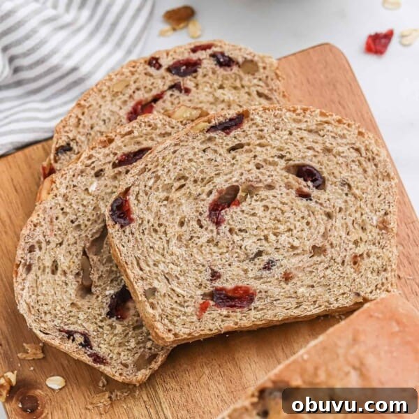 Three slices of cranberry walnut bread.