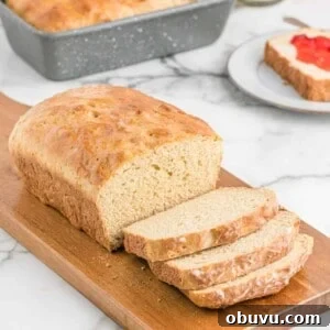 No knead whole wheat bread sliced on a cutting board.