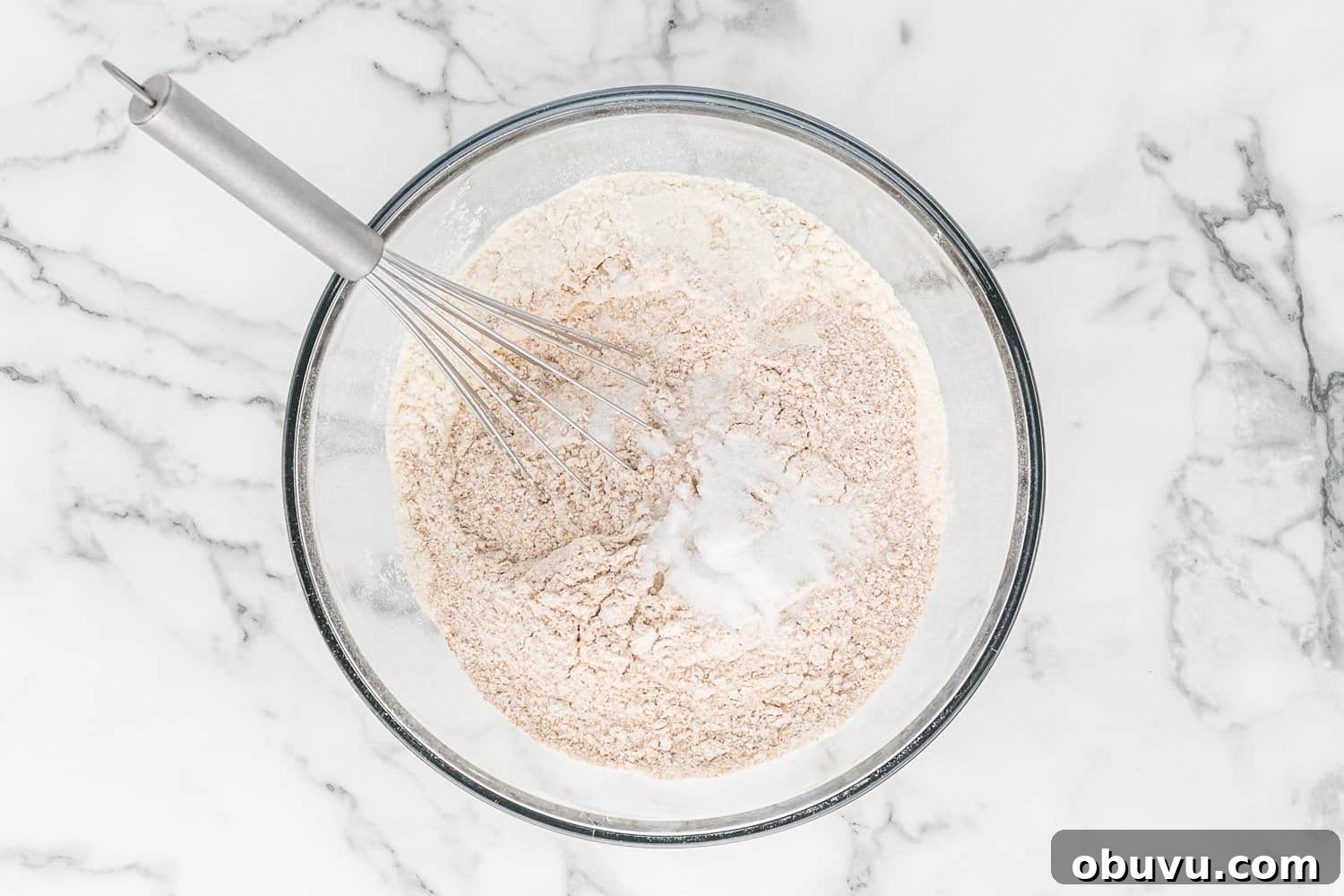 Dry ingredients in glass mixing bowl.