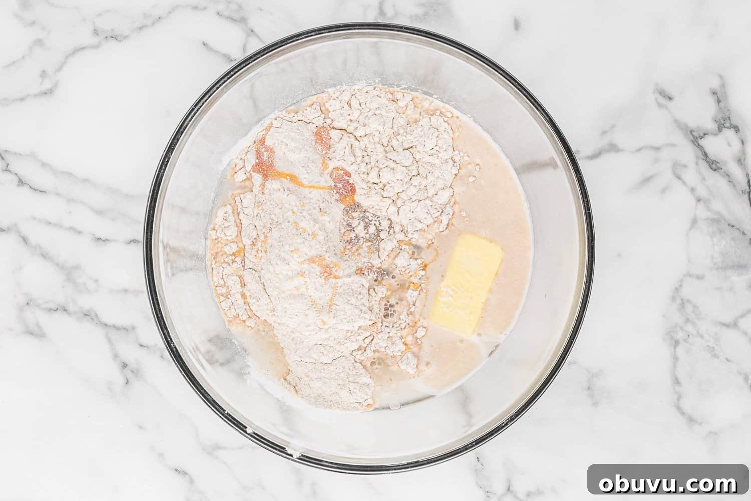 Butter and half of dry ingredients added to bowl.
