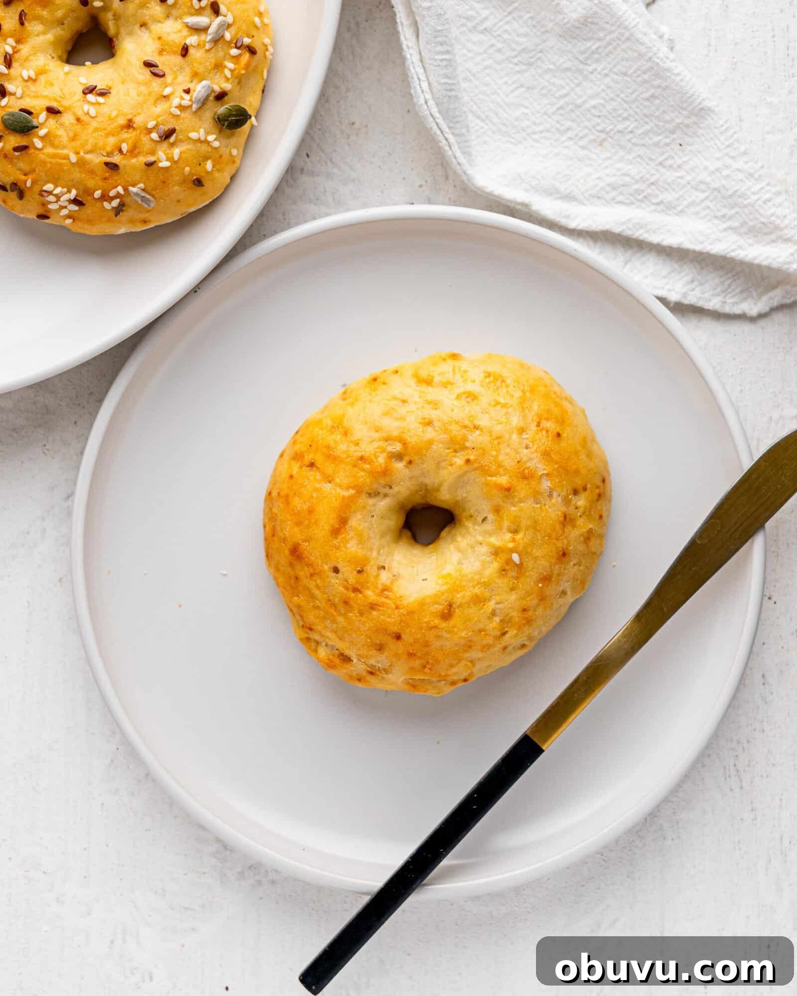 3-Ingredient Bagels Ready in 30 Minutes (No Rise) 7 A 3 ingredient bagel on a white plate.