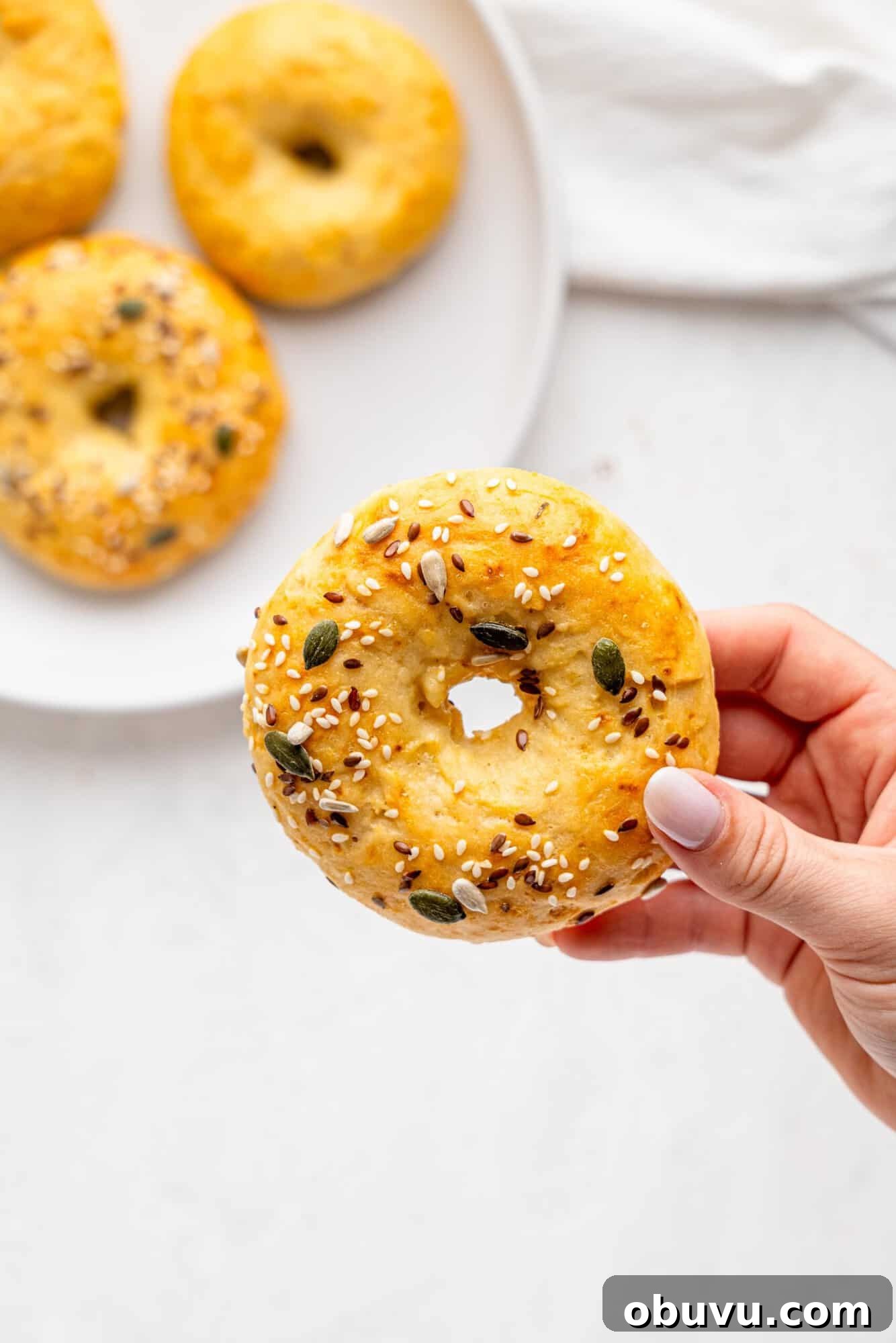 3-Ingredient Bagels Ready in 30 Minutes (No Rise) 6 A hand holding a greek yogurt bagel.