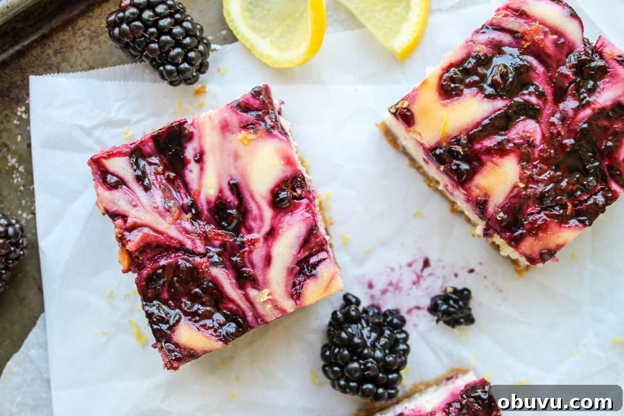 Lemon and Blackberry Dessert Bars: Zesty Summer Fruit Bars 3 blackberry lemon cheesecake bars on parchment paper.