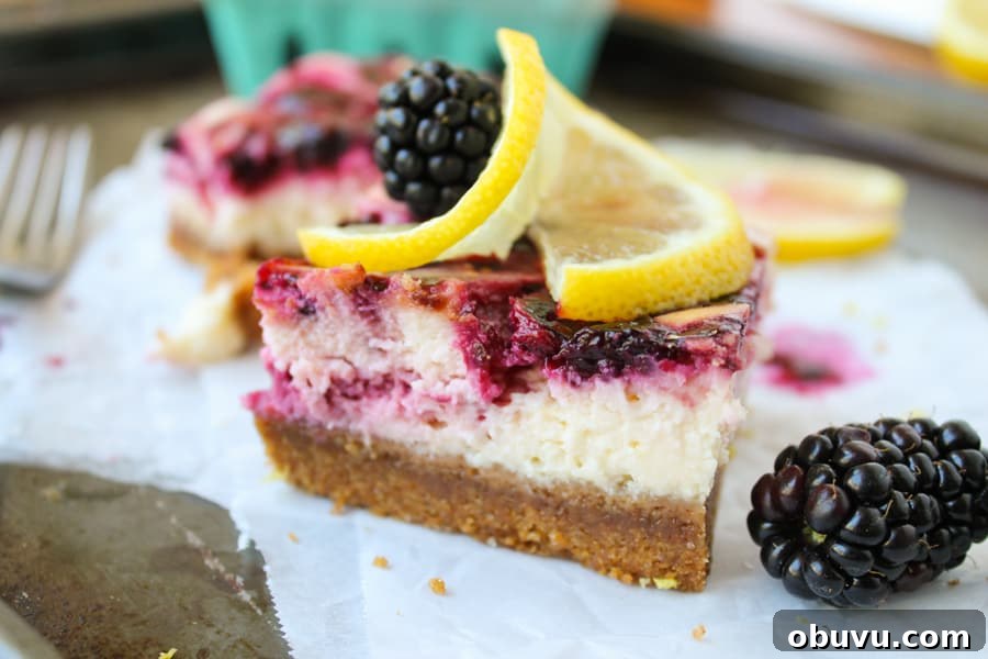 Lemon and Blackberry Dessert Bars: Zesty Summer Fruit Bars 6 a close up shot of a blackberry lemon cheesecake bar on parchment paper.