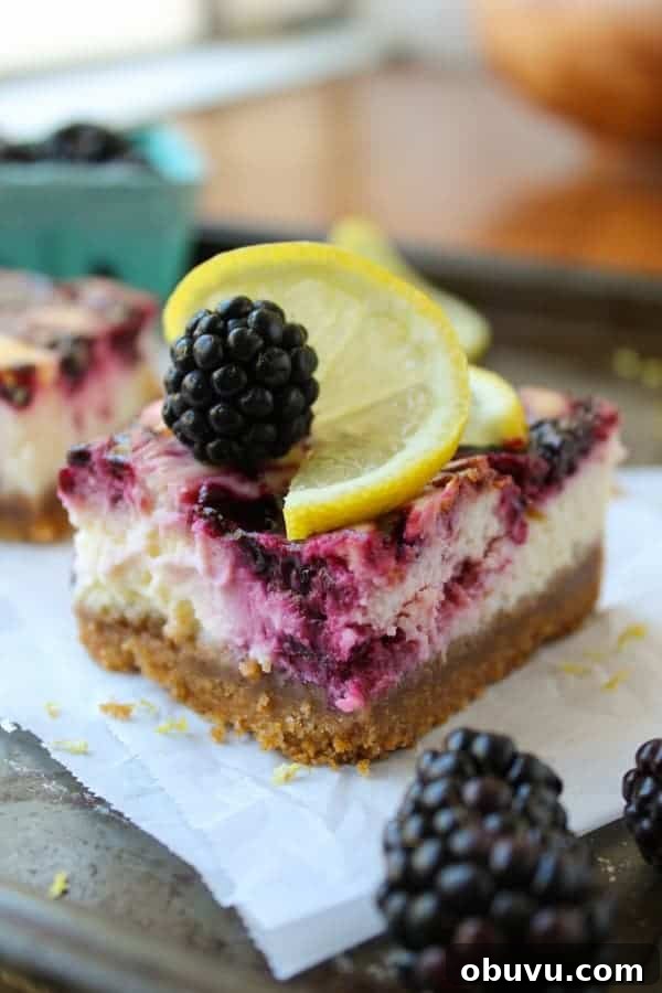 Lemon and Blackberry Dessert Bars: Zesty Summer Fruit Bars 10 a thick crust blackberry lemon cheesecake bar on parchment paper.