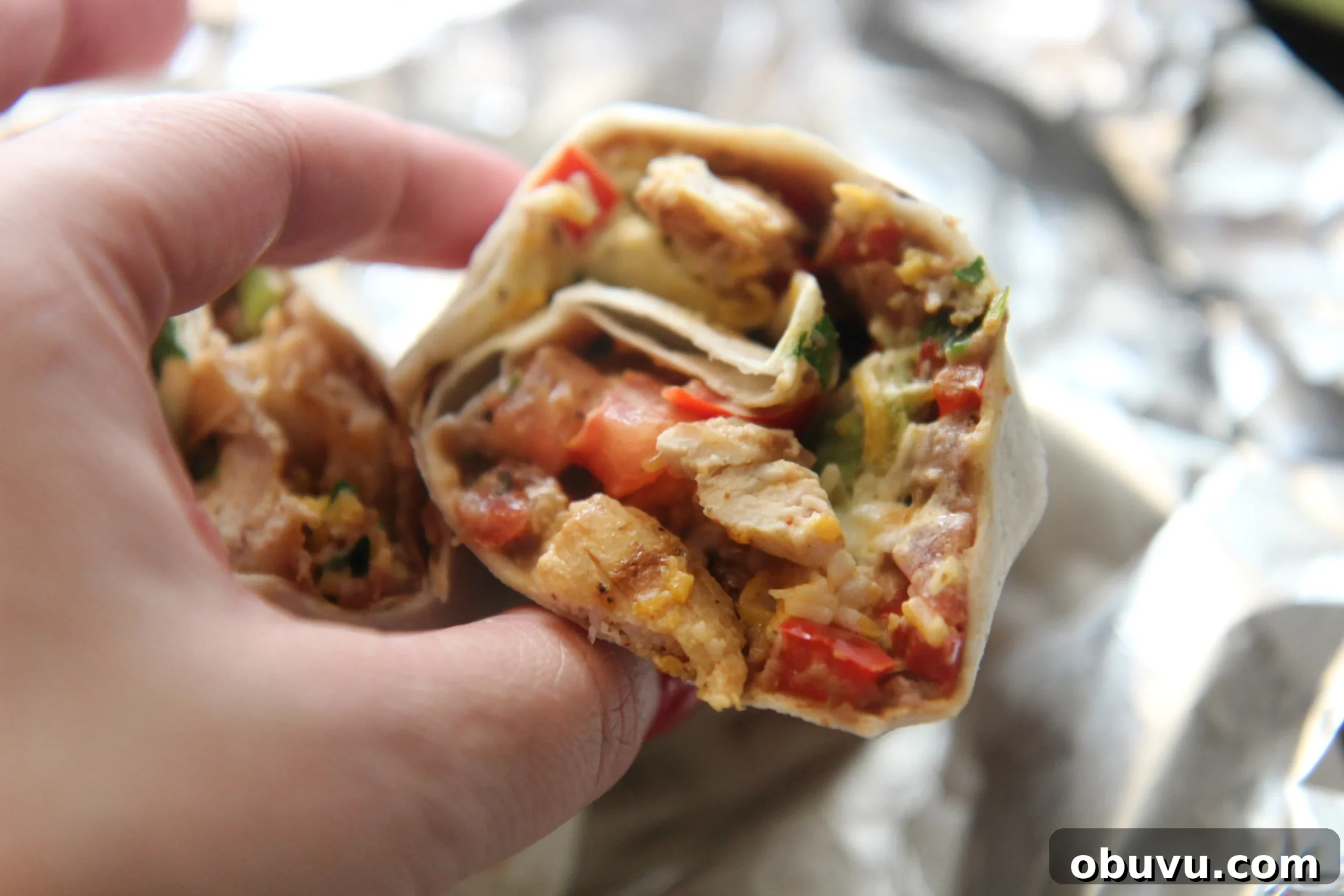 Tex-Mex Grilled Chicken Burrito Recipe: Flavorful Weeknight Meal 3 Served with sour cream and hot sauce, this Tex-Mex burrito is the perfect lunch.