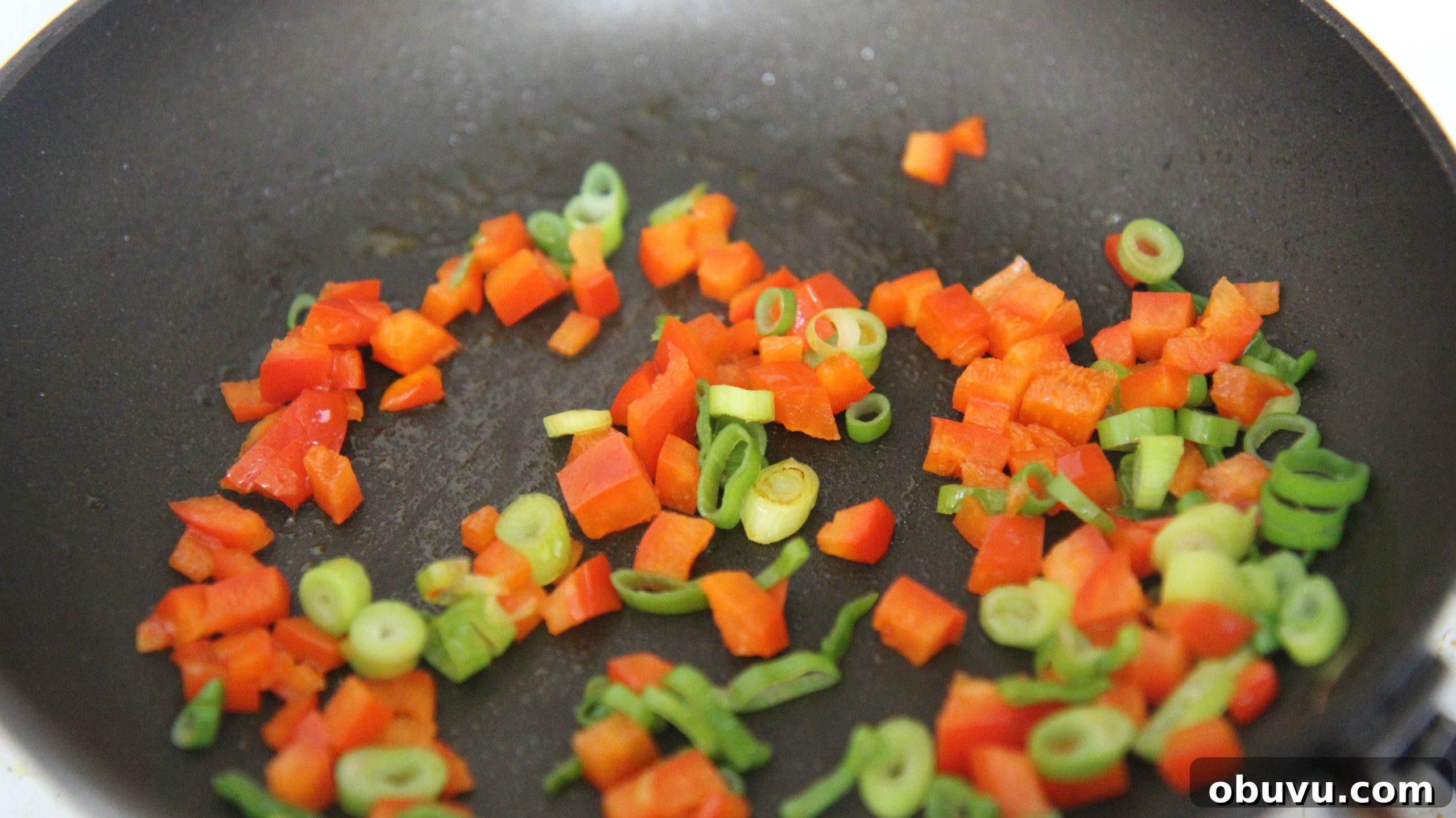 Tex-Mex Grilled Chicken Burrito Recipe: Flavorful Weeknight Meal 4 Saute chopped red bell peppers and green onions in a pan.