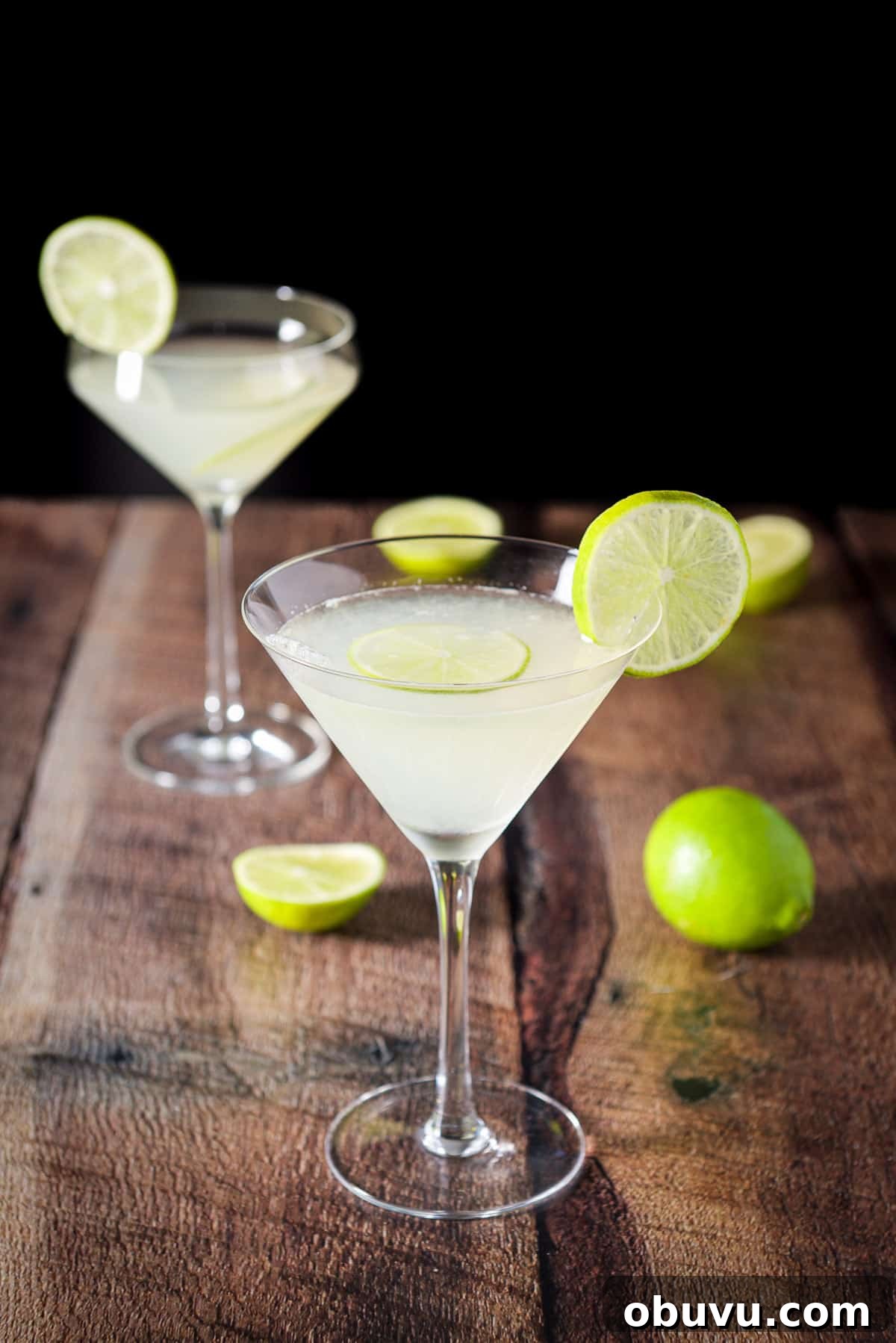 Classic Kamikaze Cocktail Recipe and Serving Tips 2 A beveled regular martini glass with another fun glass filled with the martini and garnished with lime wheels