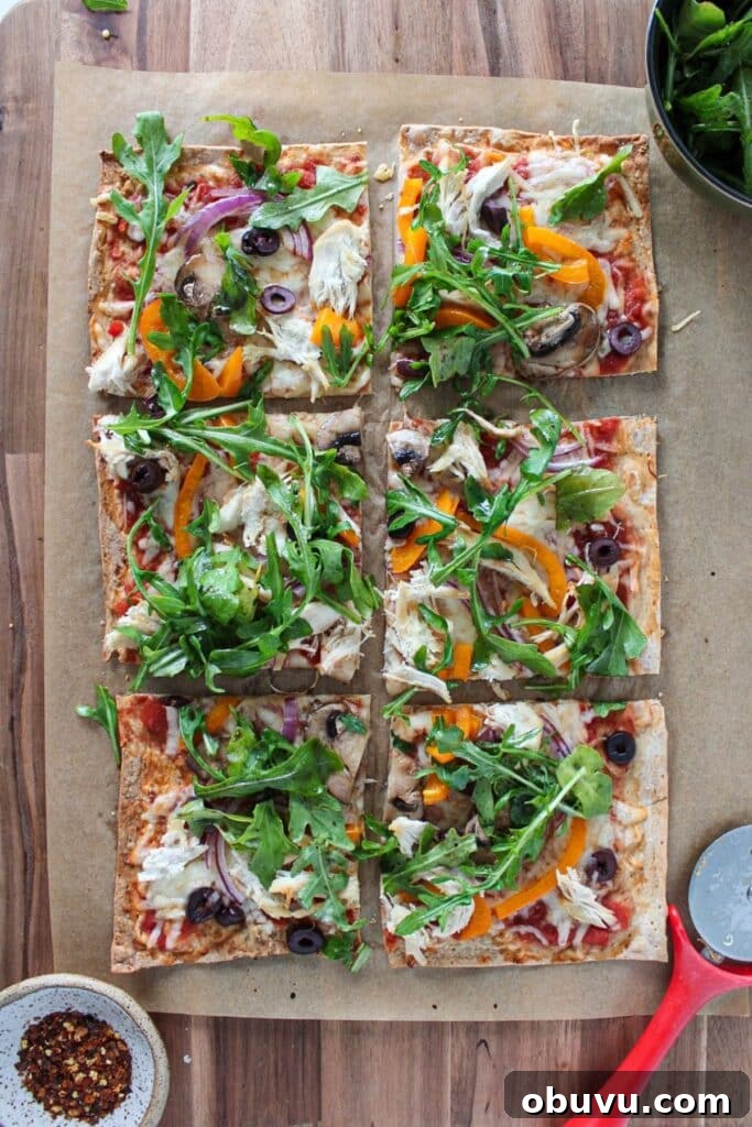 High-Protein Lavash Pizza Ready in 10 Minutes 2 Lavash bread pizza topped with arugula and cut into slices.