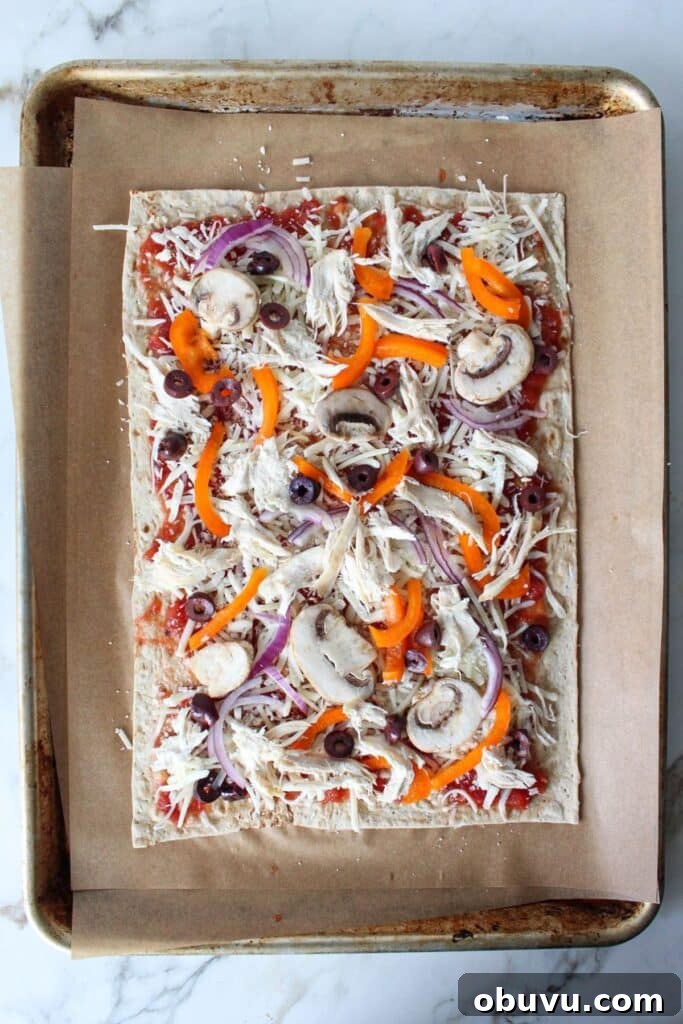 High-Protein Lavash Pizza Ready in 10 Minutes 6 A process shot of lavash bread pizza with lavash bread topped with sauce, cheese and veggies.