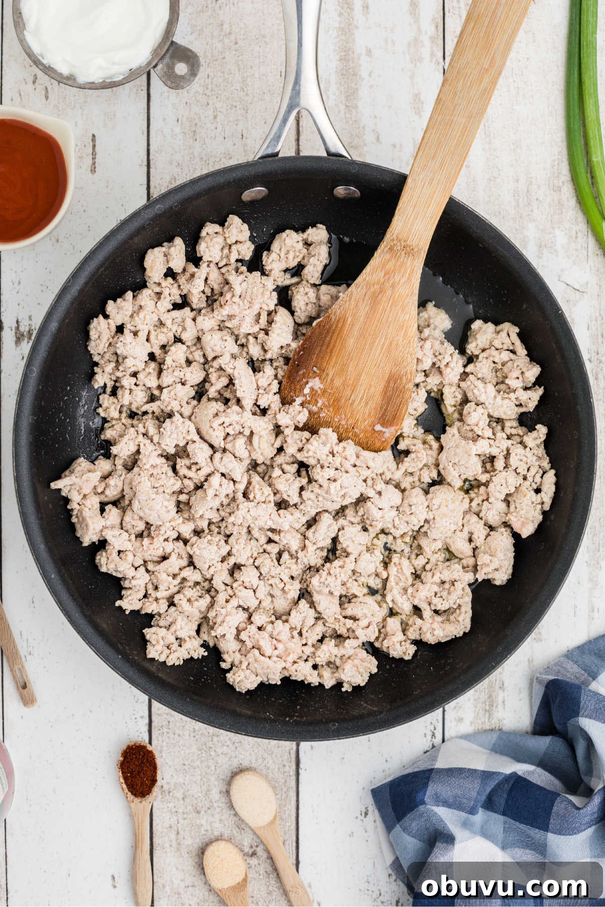 A skillet with ground chicken being browned.