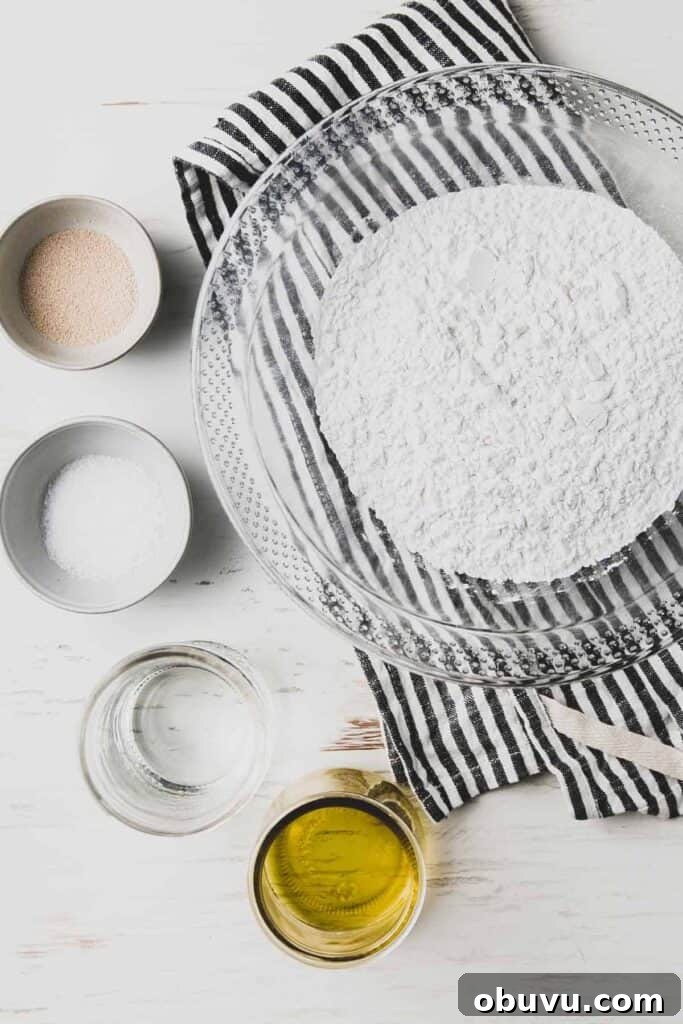 Homemade Gluten-Free Pizza Recipe: Crispy Crust & Tasty Toppings 5 Ingredients for the pizza dough: Fioreglut flour, yeast, salt, water, and oil all in separate bowls.
