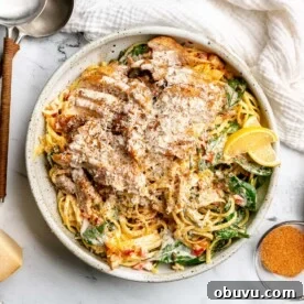 Salmon Pesto Pasta Recipe: Creamy 20-Minute Meal 12 A large plate of creamy cajun pasta topped with cajun chicken thighs