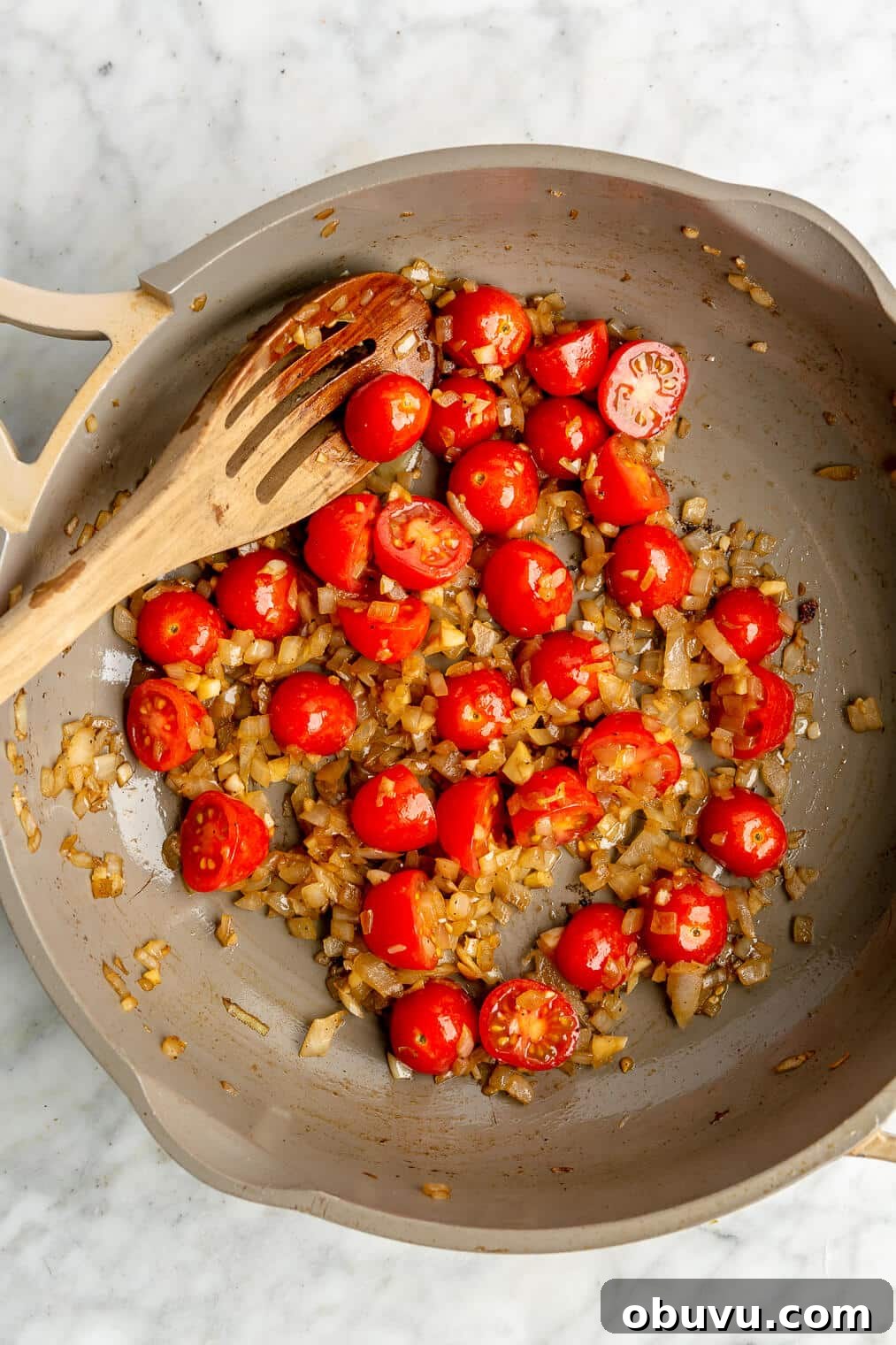 Salmon Pesto Pasta Recipe: Creamy 20-Minute Meal 7 A pan of sauteed cherry tomatoes and onion.