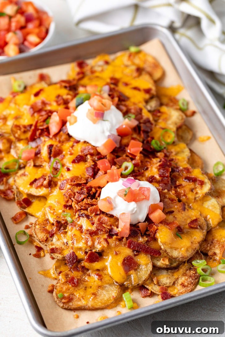 Loaded Potato Nachos with Cheese, Jalapeño & Sour Cream 2 A side angle of baked nachos.