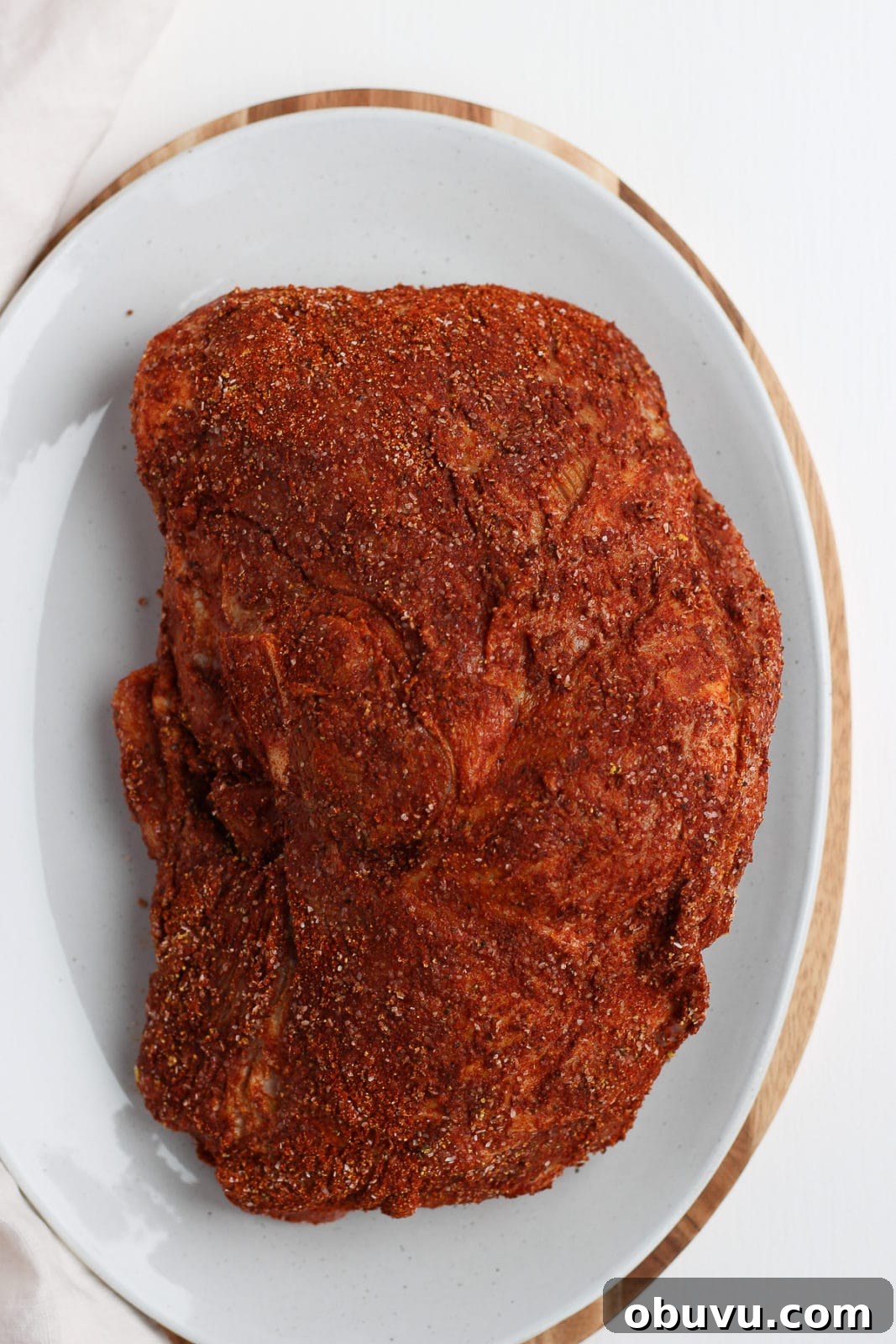 Tender Sous Vide Pork Shoulder Recipe for Juicy, Fall-Apart Meat 5 Pork shoulder covered in spice rub on a plate.