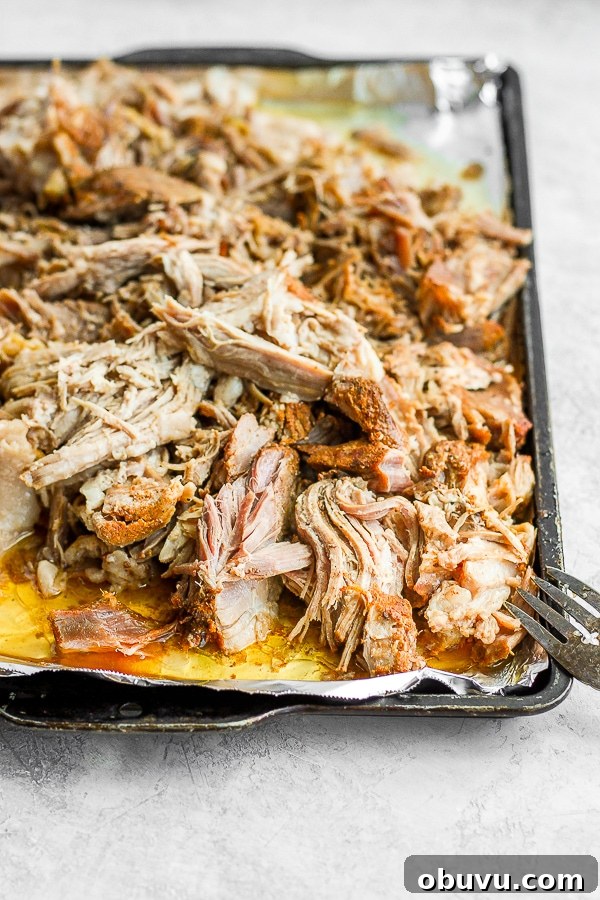 Tender Sous Vide Pork Shoulder Recipe for Juicy, Fall-Apart Meat 10 Foil-lined baking sheet with shredded sous vide pork shoulder on it.