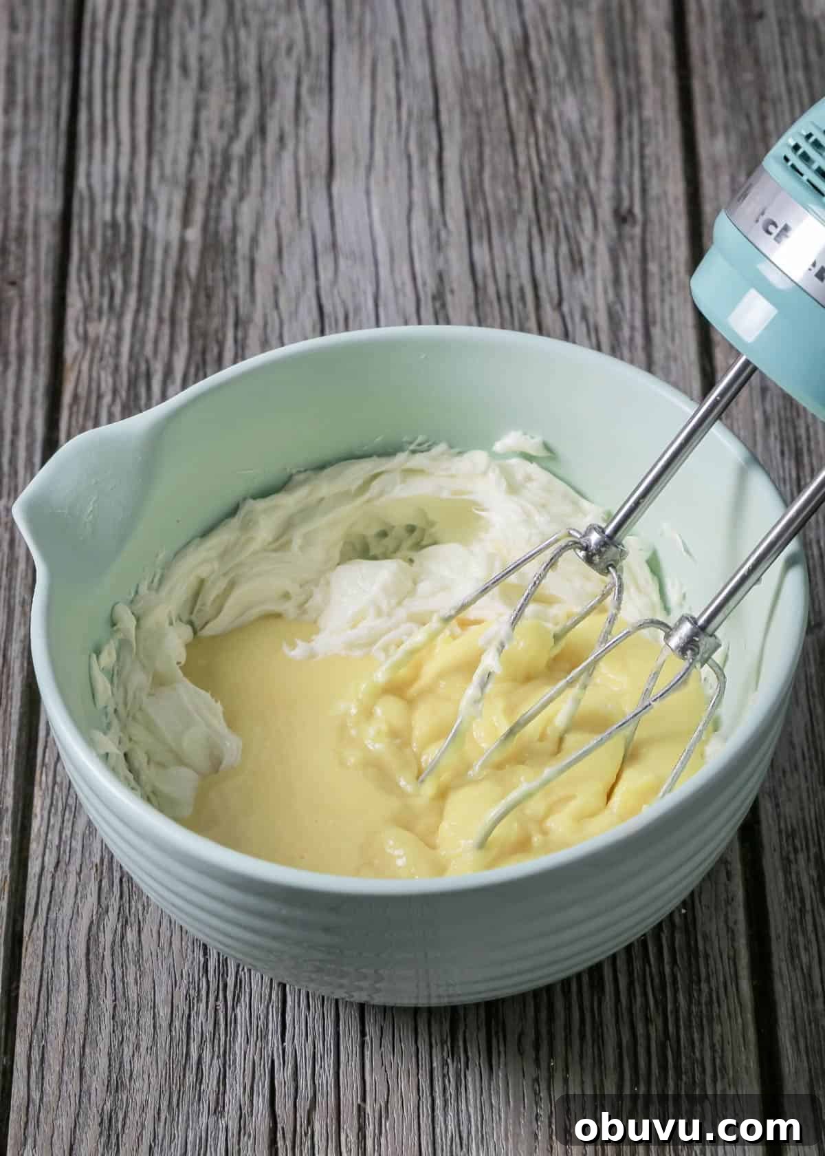 No-Bake Serbian Sand Cake Recipe — Traditional No-Heat Dessert 6 Mixing pudding with the butter in a bowl with a mixer.