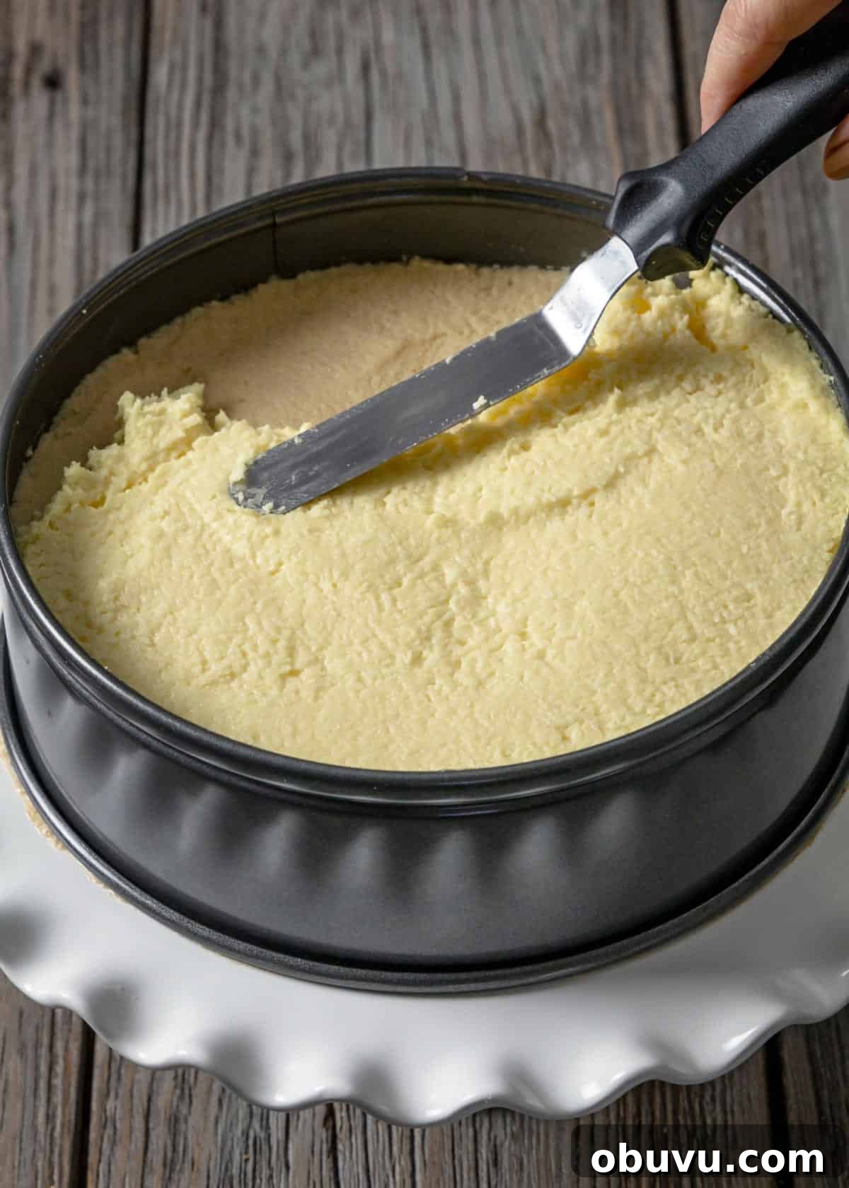 No-Bake Serbian Sand Cake Recipe — Traditional No-Heat Dessert 9 Spreading pudding coconut layer over other two sand cake layers.