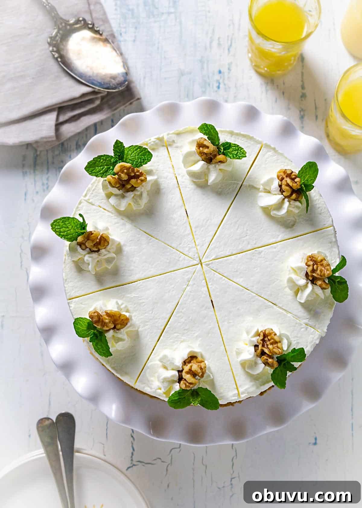 No-Bake Serbian Sand Cake Recipe — Traditional No-Heat Dessert 10 An overhead view of decorated sand cake with cool whip, walnuts, and mint leaves as garnish.