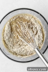 Moist Banana Bread Without Gluten — Simple Recipe for Tasty Loaf 7 Dry ingredients being whisked into wet ingredients.