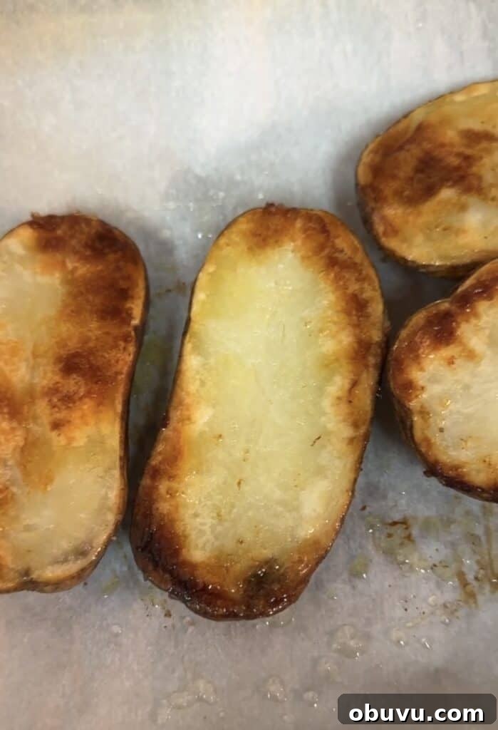 Twice-Baked Potato Stuffed with Broccoli, Spinach & Cheese 4 baked potatoes on a cookie sheet