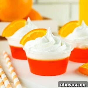 Mimosa Jello Shots Recipe: Sparkling Champagne Party Treat 10 three mimosa jello shots with whipped cream and an orange slice for garnish