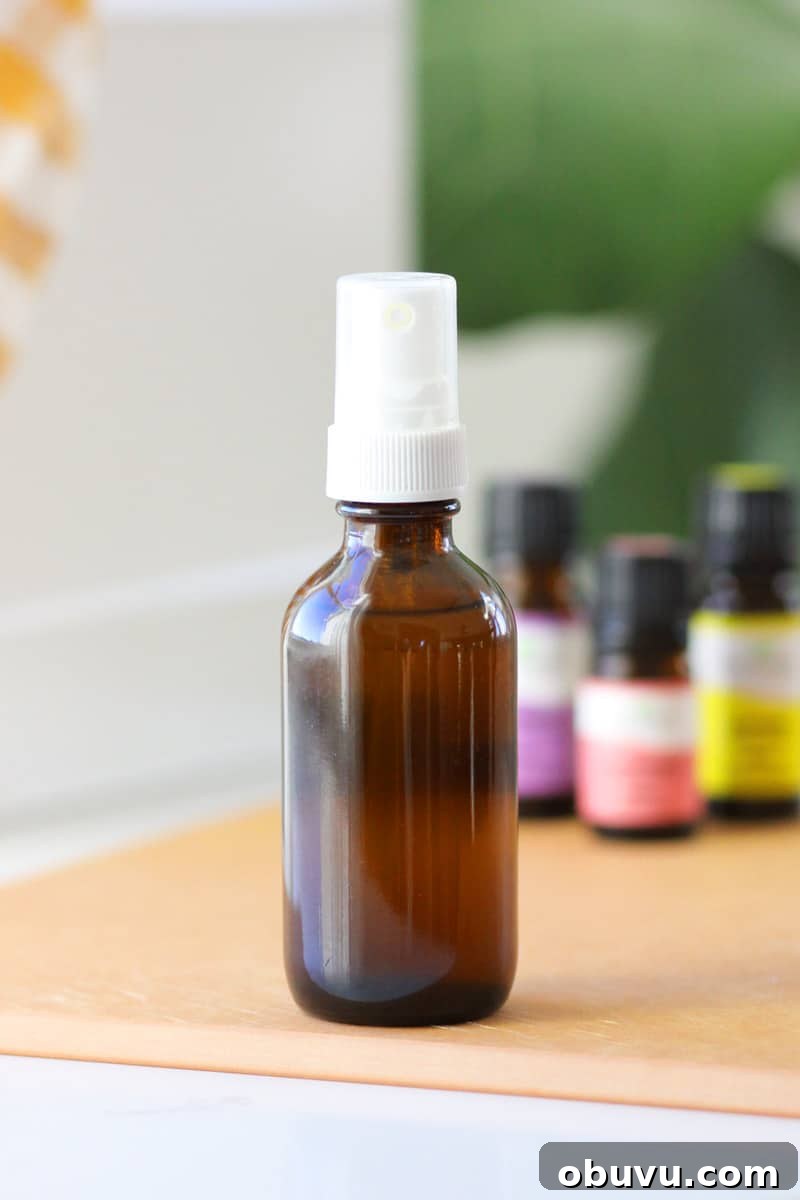 10 DIY Essential Oil Air Freshener Sprays for Every Room 2 a small glass amber spray bottle with essential oils on the table behind it