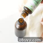 10 DIY Essential Oil Air Freshener Sprays for Every Room 3 citronella essential oil being dripped into a small glass amber spray bottle