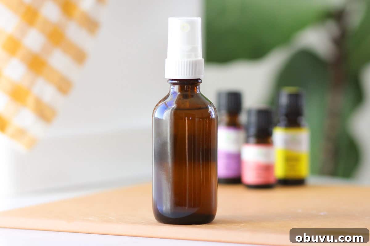 10 DIY Essential Oil Air Freshener Sprays for Every Room 5 a small glass amber spray bottle with essential oils on the table behind it