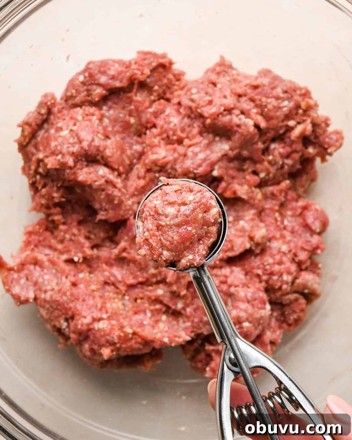 Gluten-Free Italian Meatballs Recipe – Tender & Flavorful 11 how to make Gluten Free Meatballs - measuring meatball mixture with a cookie scoop