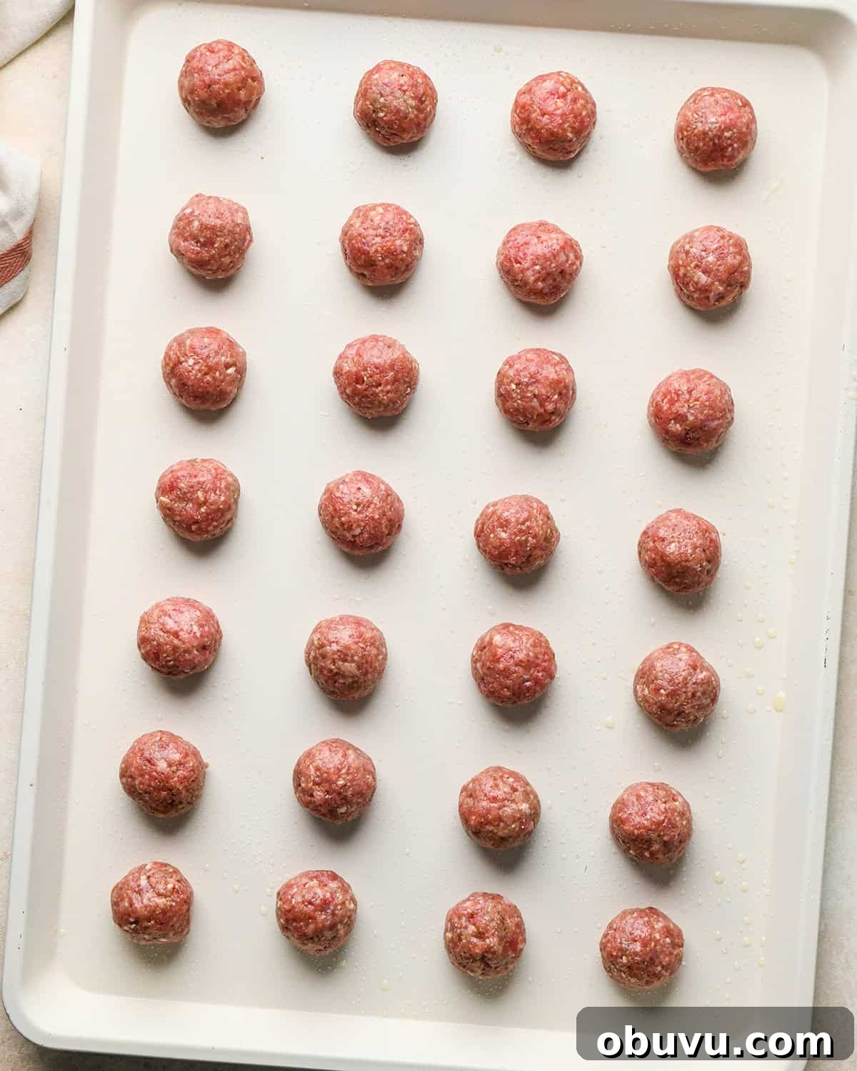 Gluten-Free Italian Meatballs Recipe – Tender & Flavorful 13 28 gluten free meatballs on a baking sheet before baking