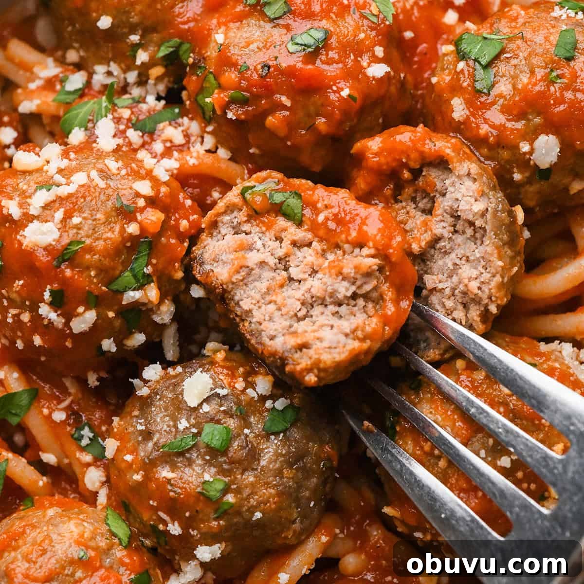 Gluten-Free Italian Meatballs Recipe – Tender & Flavorful 3 Gluten Free Meatballs in marinara sauce, one cut in half on a fork