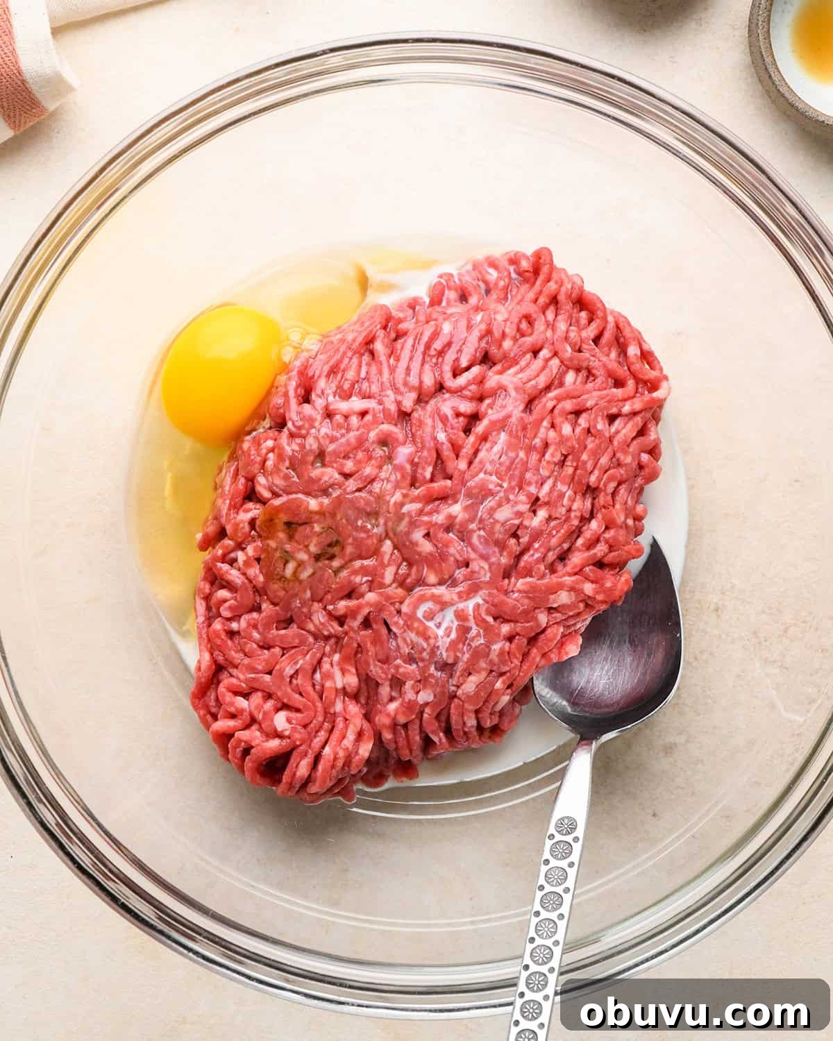 Gluten-Free Italian Meatballs Recipe – Tender & Flavorful 7 how to make Gluten Free Meatballs - ground beef, egg and milk in a bowl before mixing